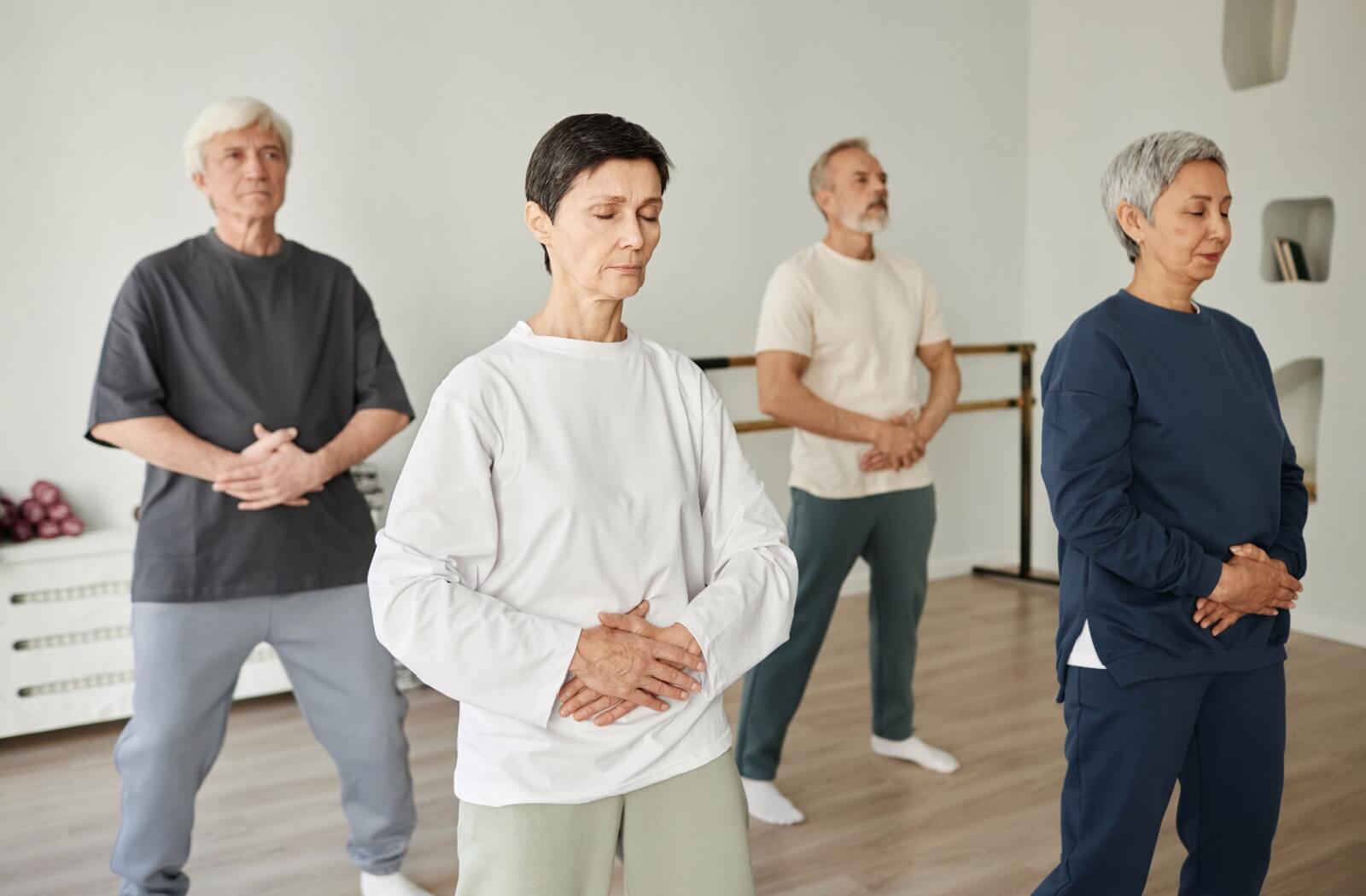 A group of older adults doing breathing exercises to improve their speech.
