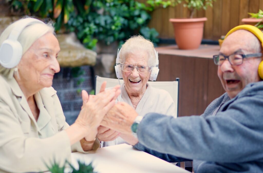 a group of older adults listening to music on headphones and socializing together.